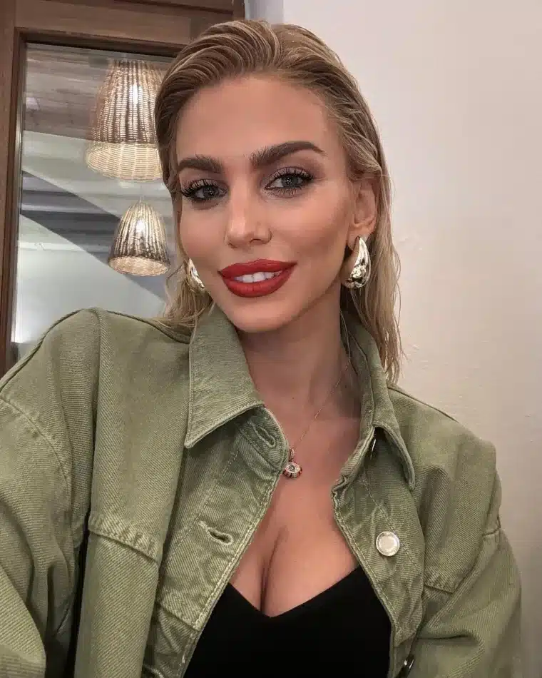 photo by valia hatzitheodwrou on may 06 2024. may be an image of 1 person blonde hair eyeliner makeup lipstick smiling parka jacket top and